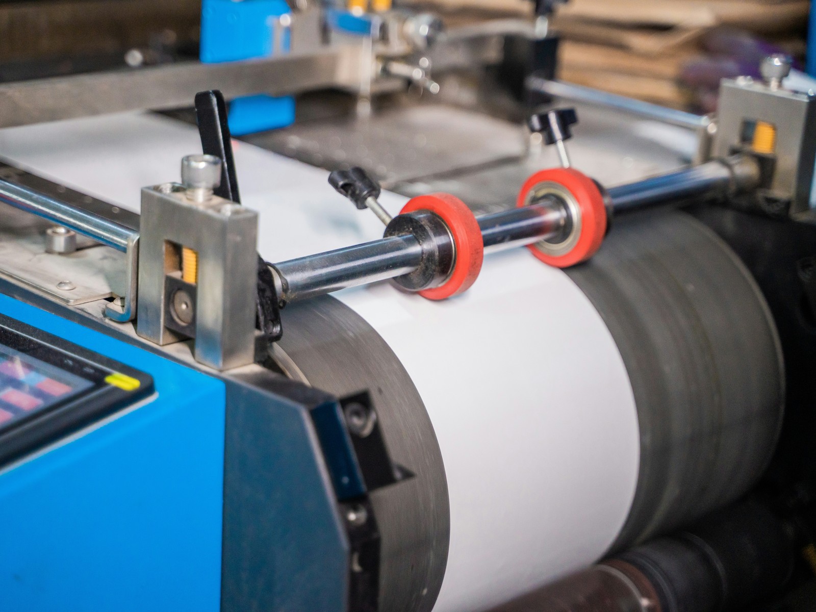 A continuous web running through the nip rollers of a laminating line — representative image